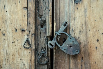 Closeup of Old iron padlock on wooden door