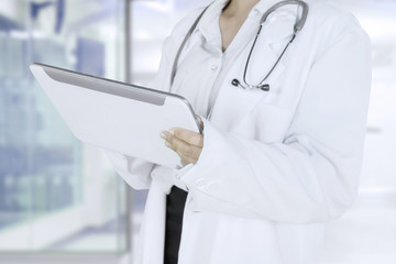 Female physician holding a tablet in the clinic