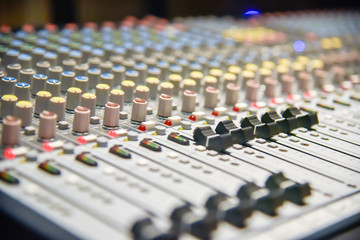 Fototapeta na wymiar Close up of digital sound audio mixer and amplifier equipment or music mixer equalizer console. Sound technician audio mixer equalizer control for background. studio music recording concept