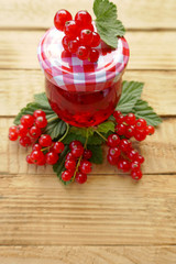 red currant jam and fresh  red currant on a wooden background. Berry season. Currant crop
