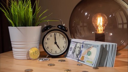 Bitcoin fast rising price. Time lapse. Close-up view of bitcoins, alarm clock and small bundle of dollars on table changing into large wad of cash in half-hour, concept of bitcoin price surge. - Powered by Adobe