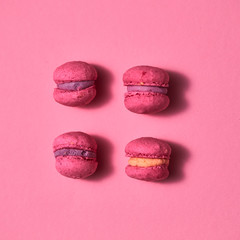 Composition of pink colored macaroon on pink background, flat lay