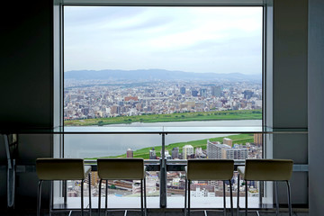 Japan Osaka aerial view from commerical building with silhouette table, chairs