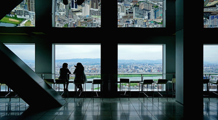 Japan Osaka aerial view from commerical building with two silhouette women