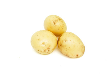 Three young raw potatoes, pile of organic vegetables, food object isolated on white background