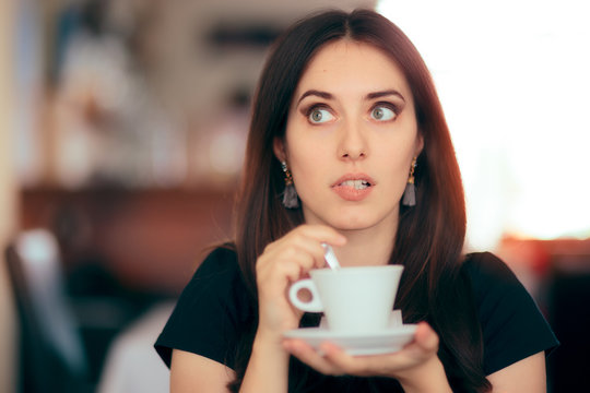 Surprised Woman Drinking Coffee in a Restaurant