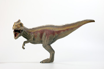 Tyrannosaurus Dinosaur Toy figurine on white background © oqba