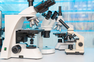 Four microscopes of different designs in the laboratory