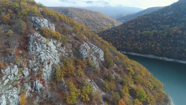 Panoramic drone flight over mountain ridge reveals blue river in Bosnia and Herzegovina