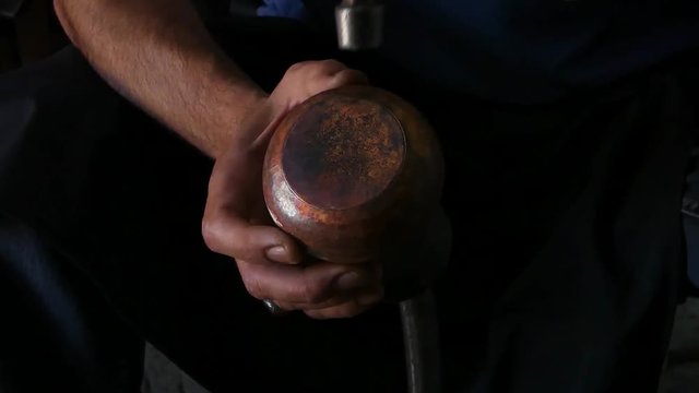 a master blacksmith produces the jug from copper. masters of Central Asia and Uzbekistan. hand-minting copper. the ancient art of making crockery