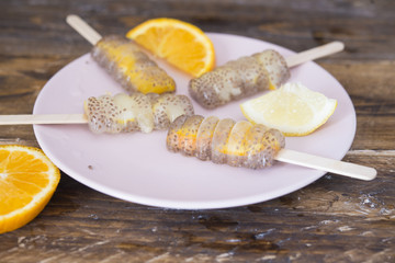 Popsicle of orange and lemon with chia