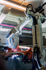 Industrial robot is welding in car factory