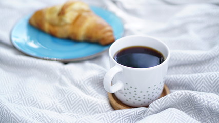 croissants, biscuits and coffee on a picnic overlay
