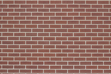 Vintage brick wall background with red clay bricks in traditional common bond pattern