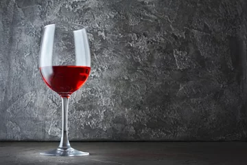 Fotobehang Single glass of red wine for tasting in dark cellar with copy space © viktoriya89
