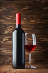 Red wine bottle and glass for tasting in cellar