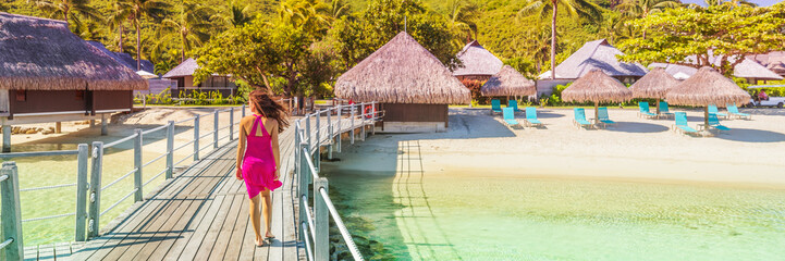 Luxury travel resort beach vacation destination in Bora Bora, Tahiti. Woman enjoying holidays...