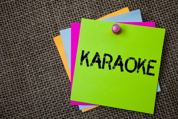 Handwriting text writing Karaoke. Concept meaning Entertainment singing along instrumental music played by a machine Sticky cards board pinned muliple colours remember idea jute background.