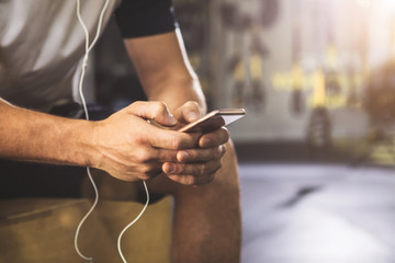 Close up man hands typing in phone while hearing song. Modern digital device concept