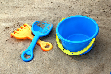 Fototapeta na wymiar children's shovel rake and bucket on the sand