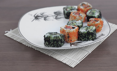 close-up of sushi and chopsticks on a white plate