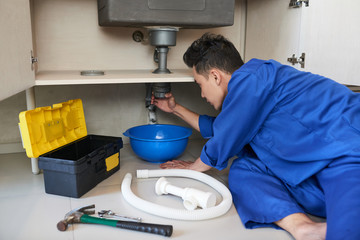 Plumber fixing pipe
