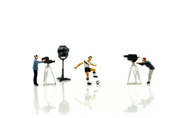Miniature people : Cameramen, photographers and reporters interviewing football player