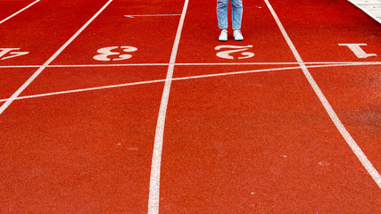 Woman stand on red running track. Business concept background.Spot concept banner background.