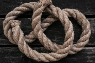 Fototapeta na wymiar Moorings rope on aged wooden table background.