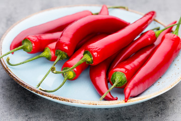 Chili cayenne pepper on grey background.
