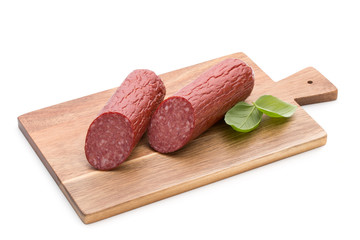 Salami smoked sausage, basil leaves on white background cutout.