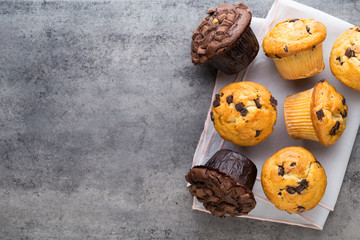 Homemade chocolate muffins on the vintage background. - obrazy, fototapety, plakaty
