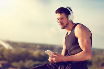 Young man chooses music on the phone