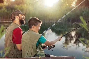 Fototapeten Happy father and son fishing together © Cherries