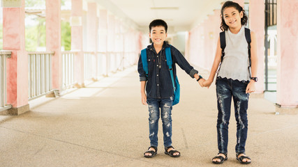 Two asian children holding hand together going to the school.education and people concept.back to school