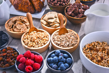 Different sorts of breakfast cereal products and fresh fruits