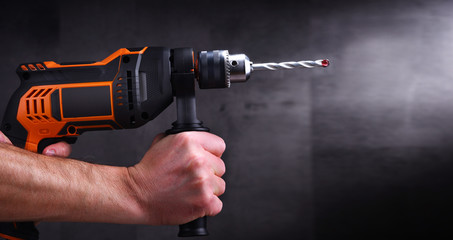 Male hands holding power drill