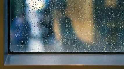 Raindrops texture on the glass window frame