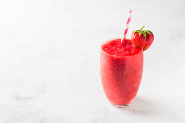 Strawberry smoothie and fresh raw berries on white background