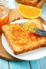 closeup toasts with orange jam on blue background