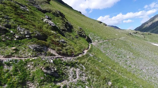 Cyclists descend from the mountain by bicycle. Downhill, extreme sport