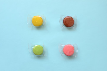 Dessert cake macaron or macaroon on trendy pastel blue background top view. Flat lay composition