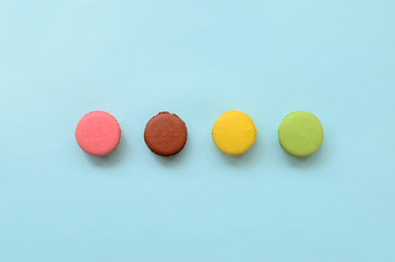 Dessert cake macaron or macaroon on trendy pastel blue background top view. Flat lay composition