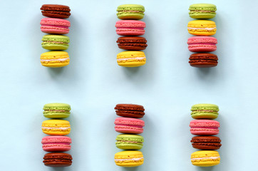 Dessert cake macaron or macaroon on trendy pastel blue background top view. Flat lay composition