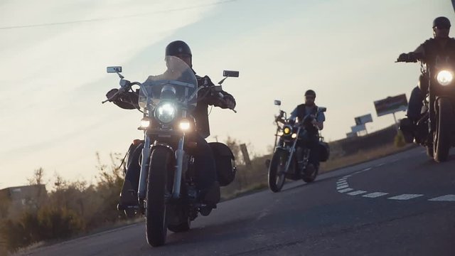 a lot of subculture bikers group ride on the track on a Sunny summer day on custom motorcycles, a large-scale action of motorcyclists. a passion for traveling by a group of men