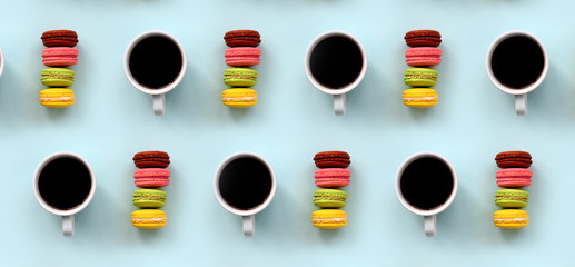 A pattern of many colorful dessert cake macaroon and coffee cups on trendy pastel blue background top view. Flat lay composition