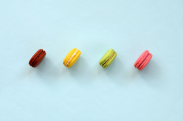 Dessert cake macaron or macaroon on trendy pastel blue background top view. Flat lay composition
