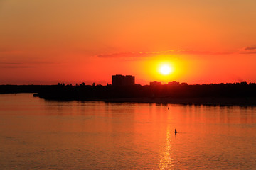 Orange sunset over a river Dnieper in Kremenchug city, Ukraine