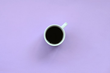 Small white coffee cup on texture background of fashion pastel violet color paper in minimal concept