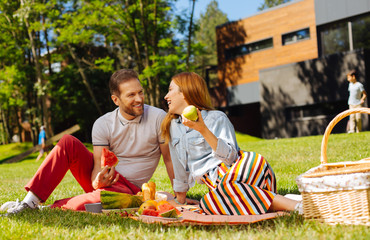 Precious moments. Happy bearded man holding watermelon and talking with his wife